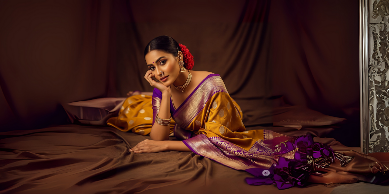 Load video: &quot;A graceful South Indian woman dressed in a traditional cream and red Kanchipuram silk saree walks through a sunlit temple corridor. The camera captures close-up details of her intricate gold jewelry, silk saree border, and soft expressions. She folds her hands in a namaste, twirls gently to showcase the saree, and ends with a soft smile while saying, &#39;Shop now at vaidehivastra.com.&#39; The video highlights the elegance, craftsmanship, and cultural richness of Vaidehi Vastra’s bridal collection.&quot;